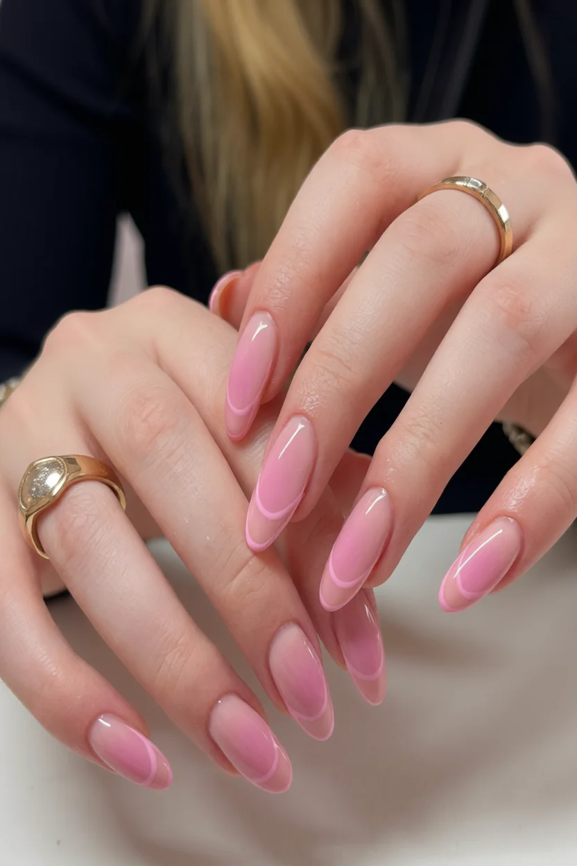 Uñas largas en forma de almendra con degradado rosa suave a blanco y puntas francesas delicadas
