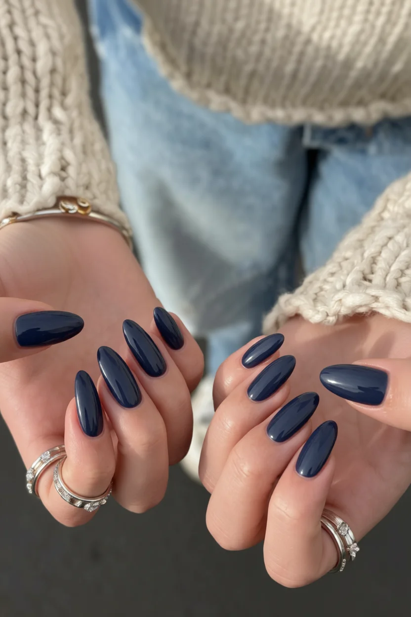 Uñas en forma de almendra con esmalte azul marino sólido y brillo intenso